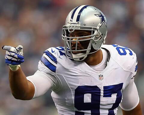 Dallas Cowboys football player in uniform pointing during game action.