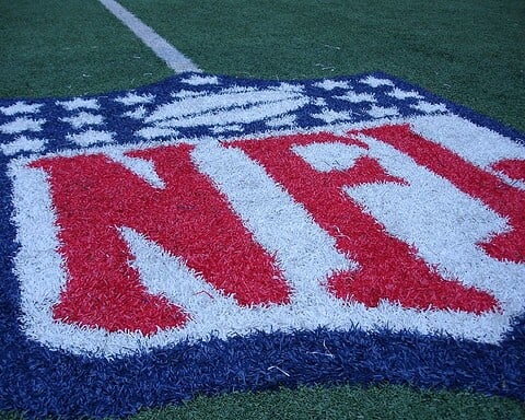 NFL logo on the Dallas Cowboys football field, focusing on American football, team branding, and sports stadium elements.