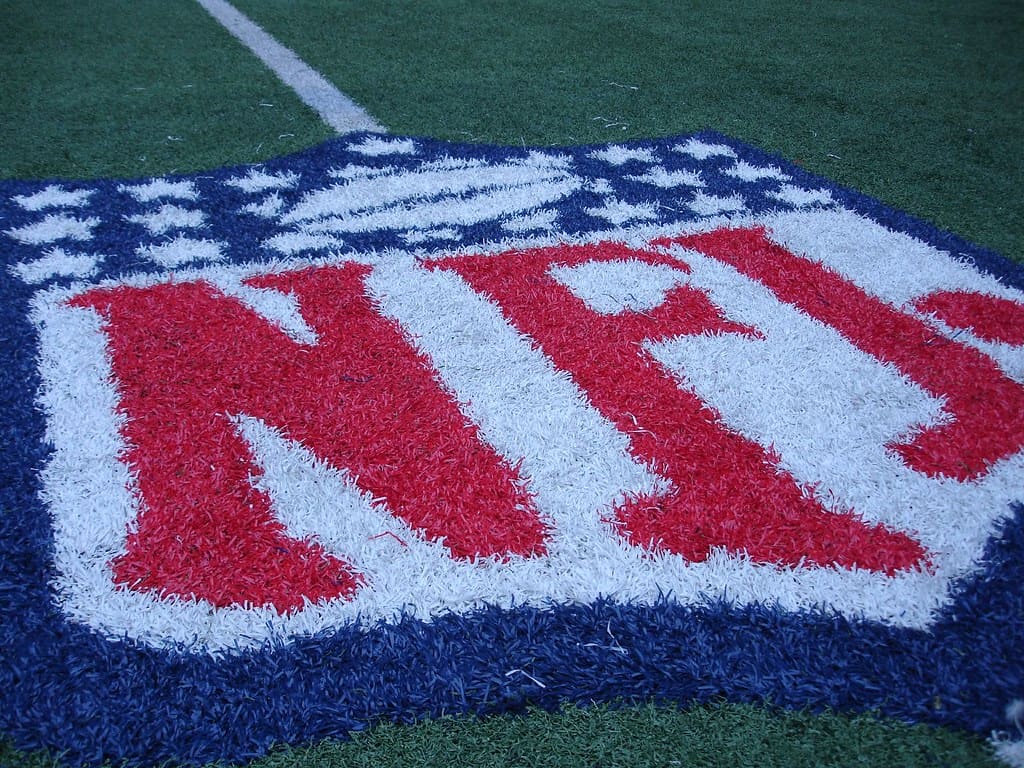 NFL logo on the Dallas Cowboys football field, focusing on American football, team branding, and sports stadium elements.
