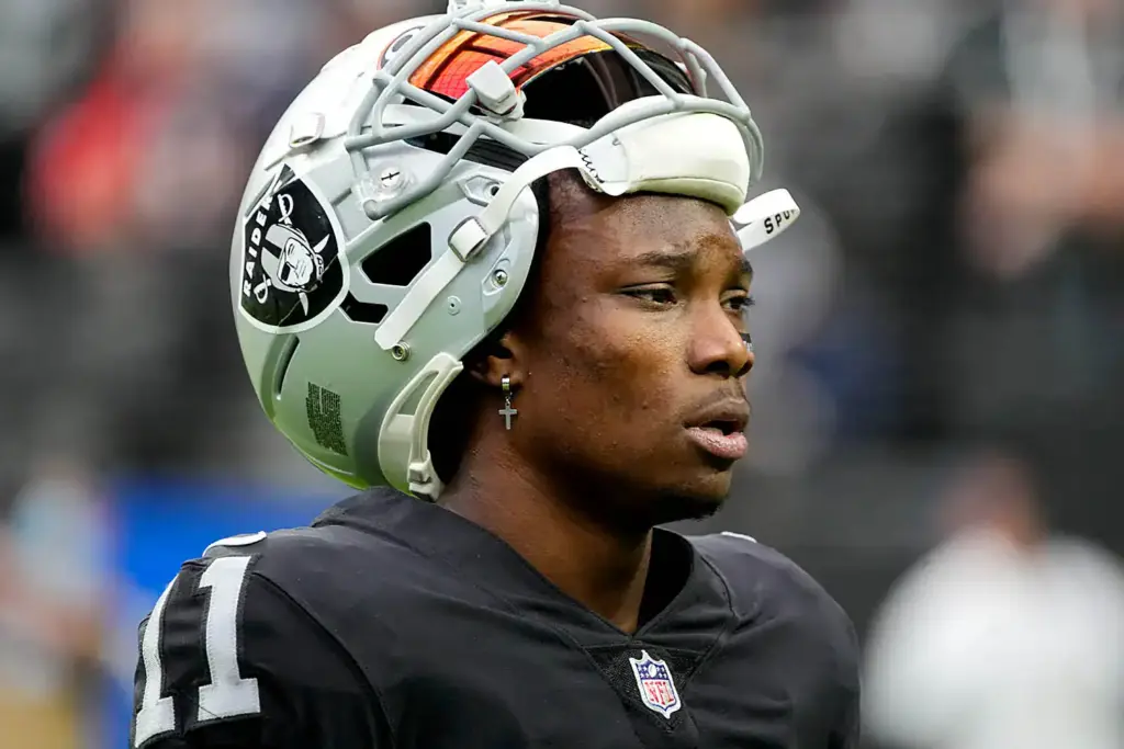 Football helmet worn by Oakland Raiders player on the field, close-up shot during game.