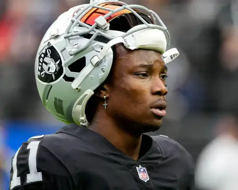 Football helmet worn by Oakland Raiders player on the field, close-up shot during game.