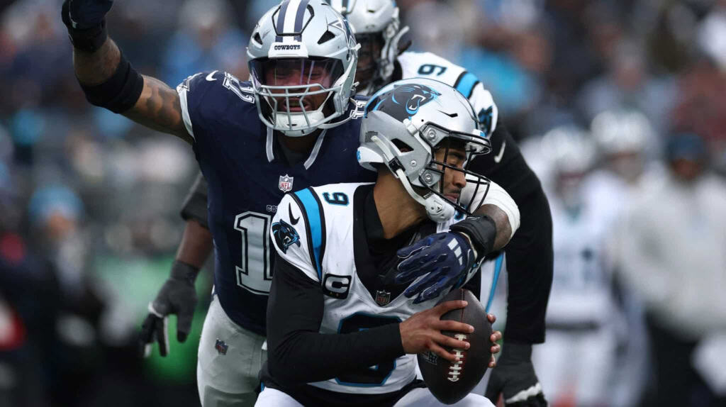 Donovan Peoples-Jones catches a football during an NFL game between the Dallas Cowboys and the Carolina Panthers, showcasing American football action and player team uniforms.
