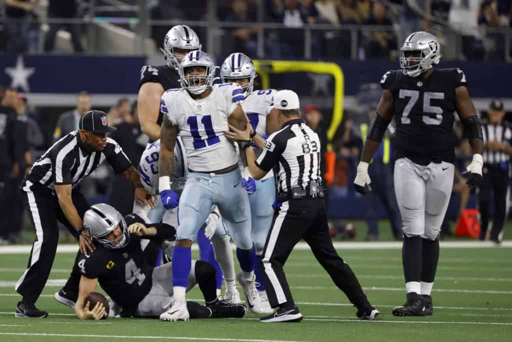Dallas Cowboys quarterback Dak Prescott celebrates after an injury on the field during an NFL game against the Las Vegas Raiders at AT&T Stadium, showcasing key moments and player reactions.