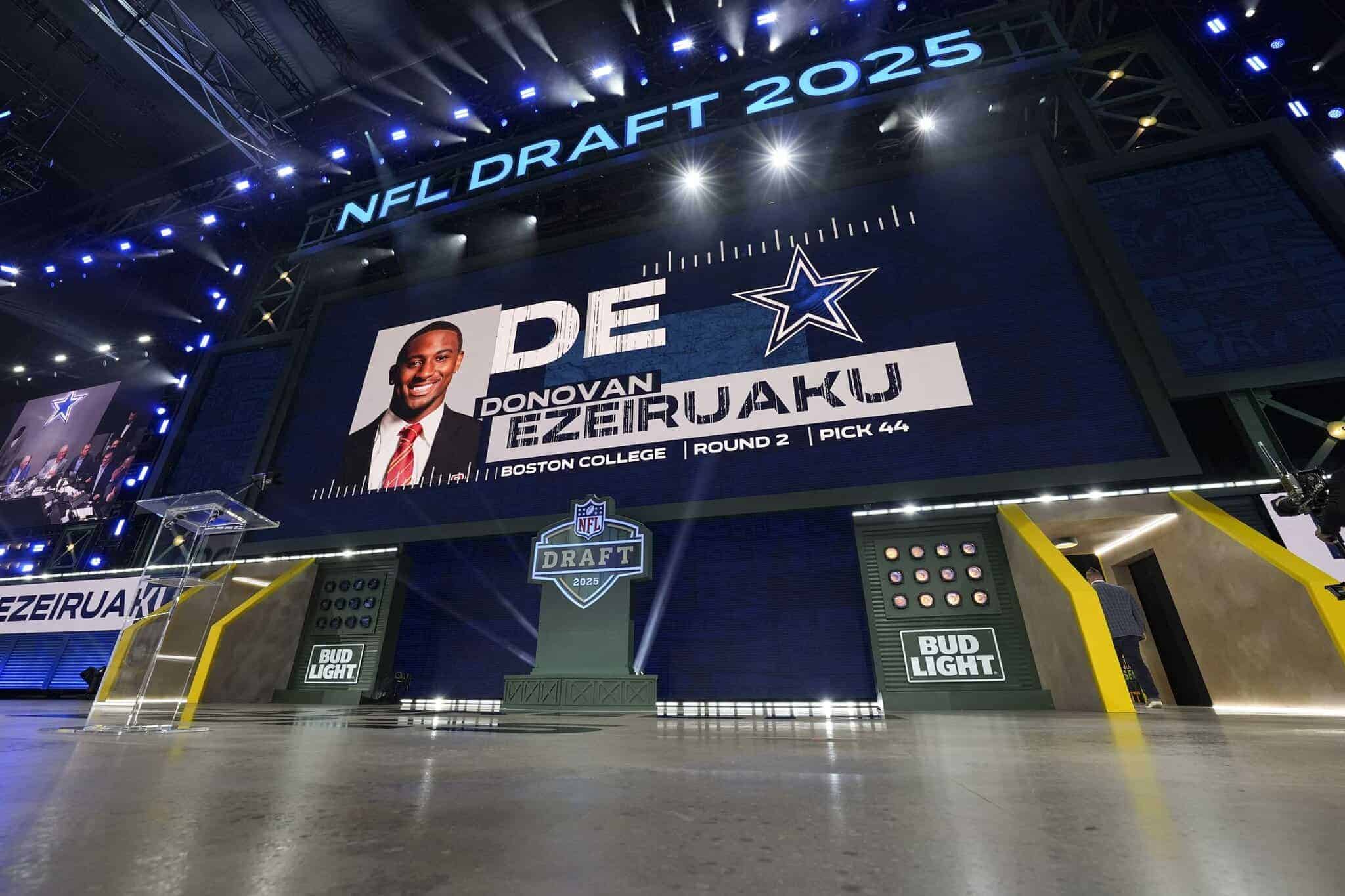 Draft event stage with large digital screen showcasing NFL Draft 2025; Dallas Cowboys logo and player Donovan Ezeiruaku; modern lighting and branding elements for inside the star focus.
