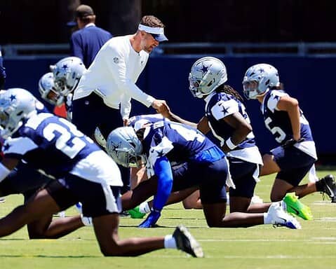 The cowboys are practicing on the field.