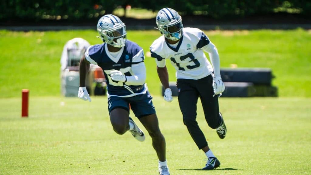 Fast-paced football practice featuring Dallas Cowboys players on a lush green field, emphasizing team training, athleticism, and NFL preparation with players in full uniform and helmets.