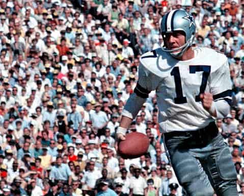 Running Dallas Cowboys quarterback with helmet wearing jersey number 17 holding football on field filled with cheering crowd.