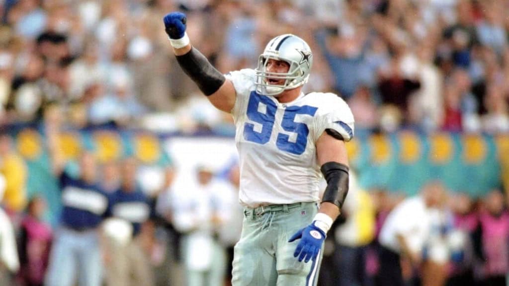 Dallas Cowboys football player wearing jersey number 95 celebrating on the field during a game.