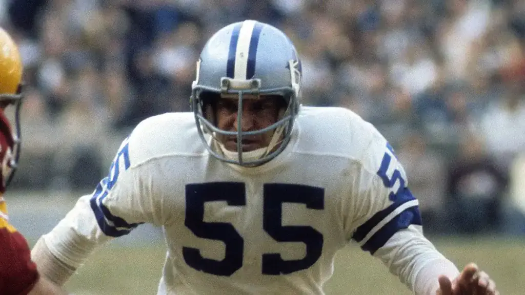 A football player from the Dallas Cowboys wearing jersey number 55 during a game, demonstrating intense focus and athletic performance on the field.
