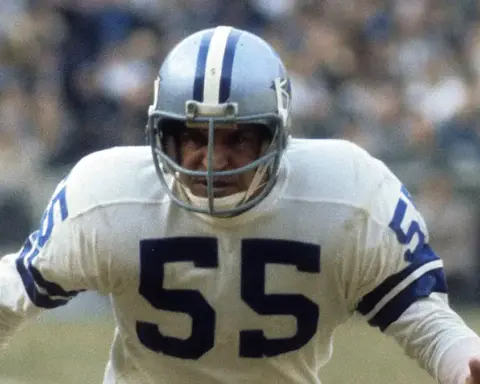 A football player from the Dallas Cowboys wearing jersey number 55 during a game, demonstrating intense focus and athletic performance on the field.