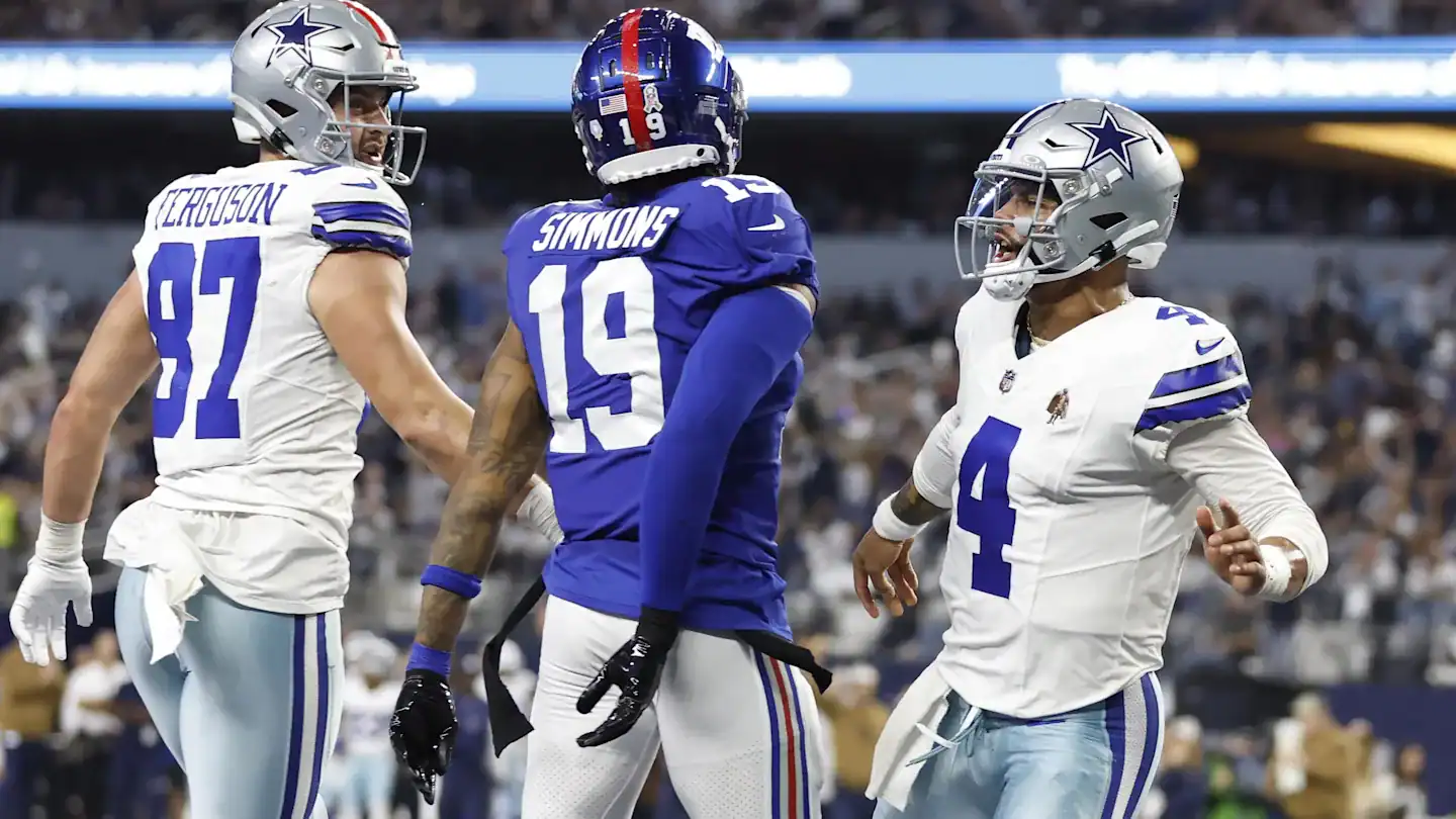 Dallas Cowboys football players on the field celebrating during a game. Wide receiver CeeDee Lamb, quarterback Dak Prescott, and wide receiver Jake Ferguson engaging in team dynamics.