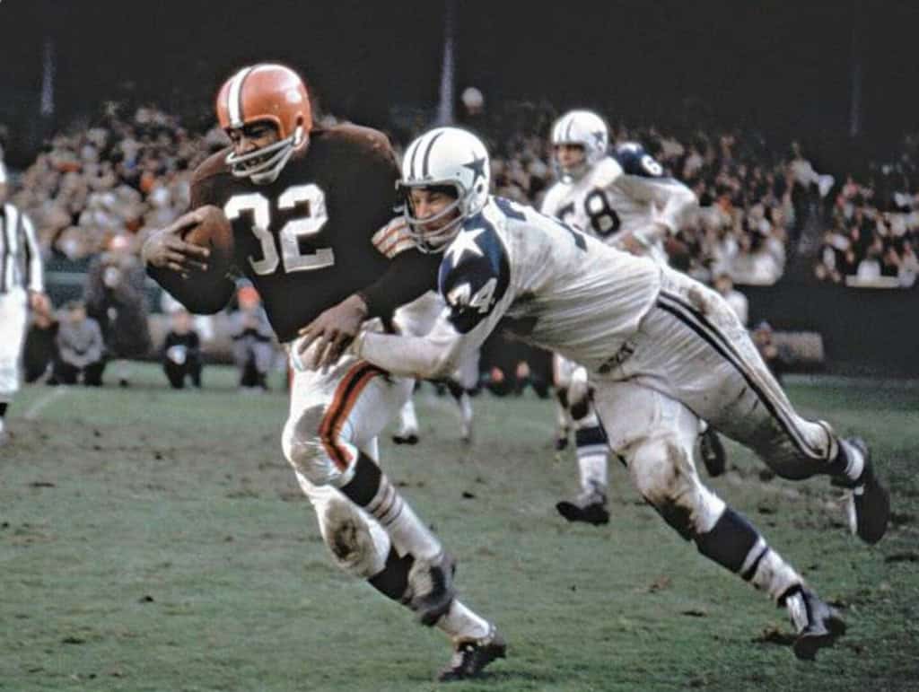 Running back carrying football during a Dallas Cowboys and Cleveland Browns game; action shot in NFL football game; Inside The Star sports coverage.