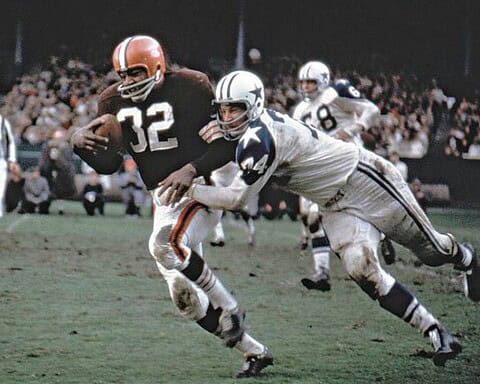 Running back carrying football during a Dallas Cowboys and Cleveland Browns game; action shot in NFL football game; Inside The Star sports coverage.