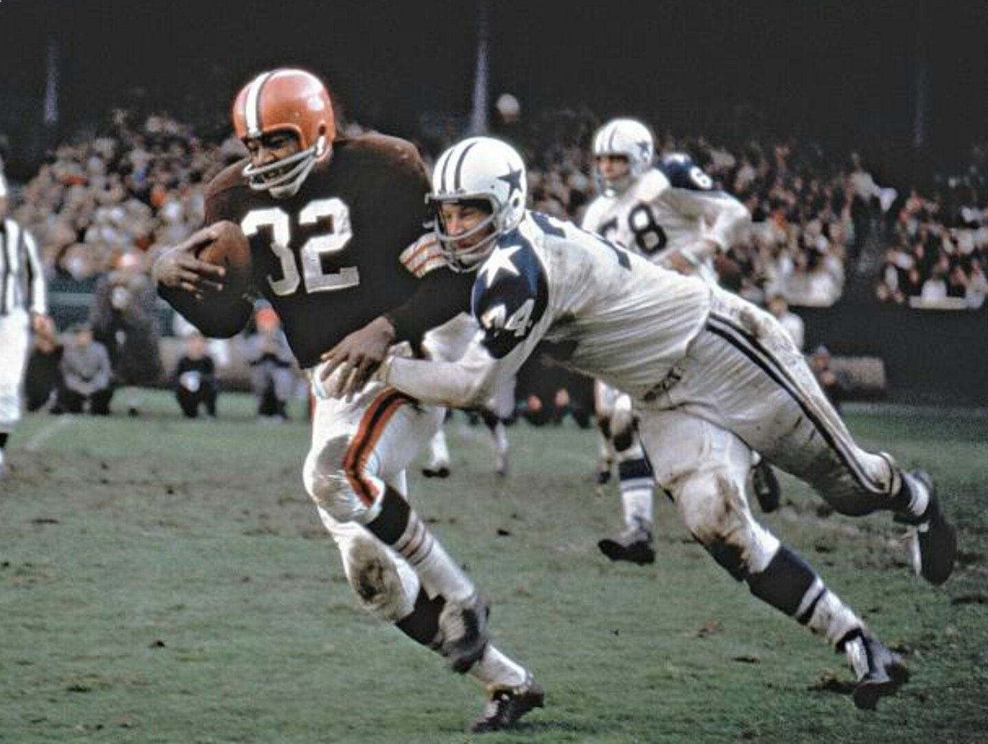 Running back carrying football during a Dallas Cowboys and Cleveland Browns game; action shot in NFL football game; Inside The Star sports coverage.