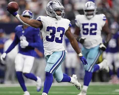Dallas Cowboys football player celebrating touchdown on the field during game.