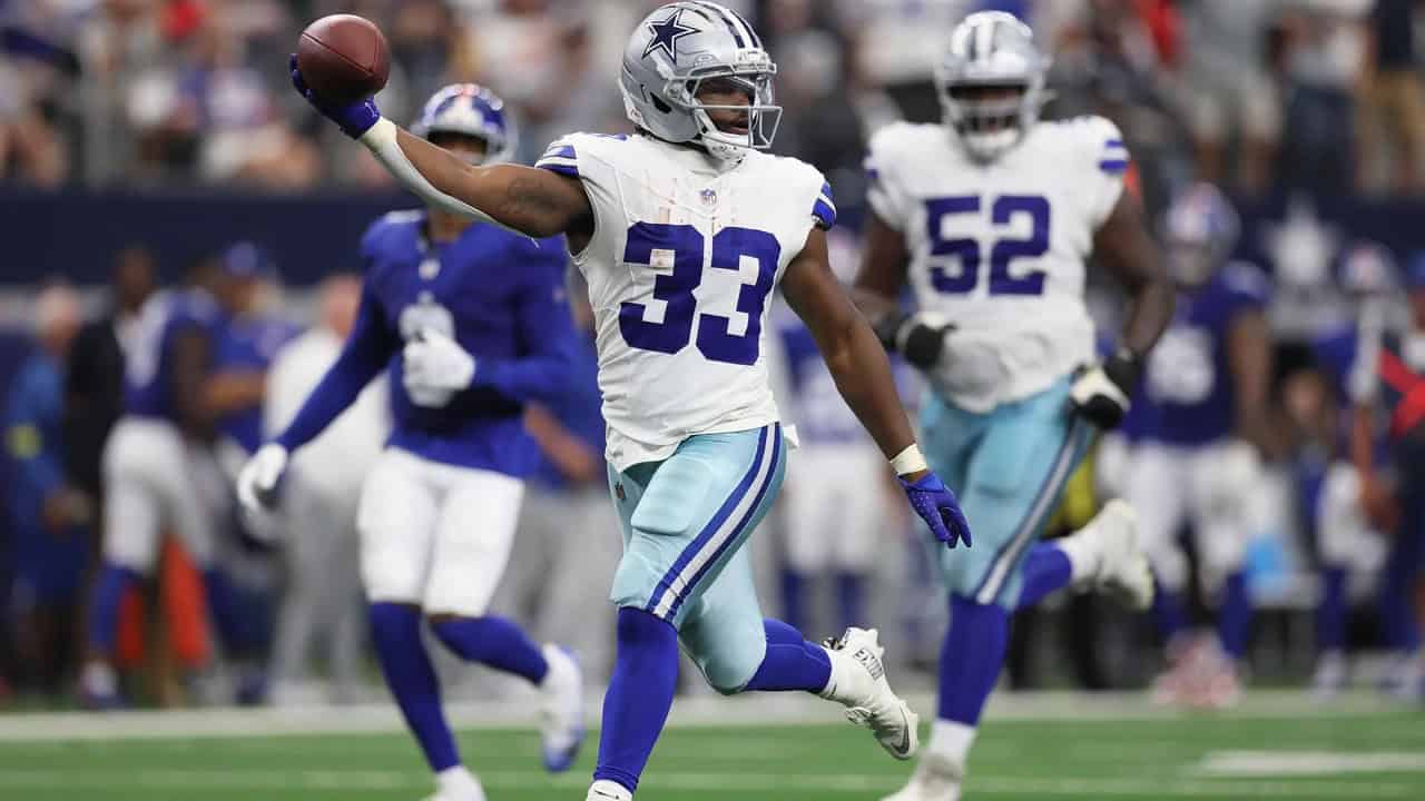 Dallas Cowboys football player celebrating touchdown on the field during game.