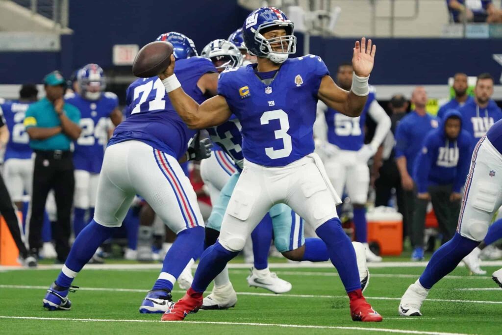 Quarterback Daniel Jones with the New York Giants, preparing to throw a pass during an NFL game. The image showcases football action, team jersey details, and the stadium environment, emphasizing the Giants' team spirit.