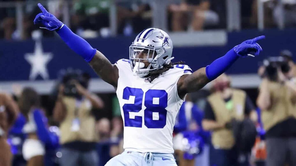 Line 1: Dallas Cowboys football player celebrating on the field during a game.