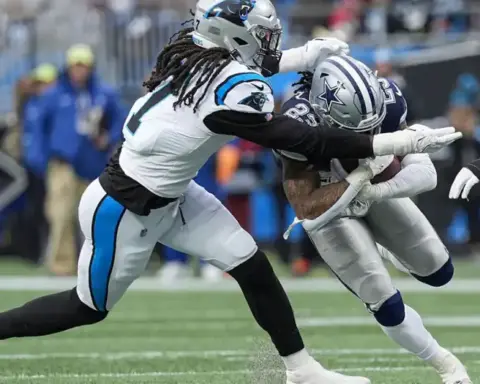 - A football player from the Dallas Cowboys being tackled by an opponent during an NFL game.
