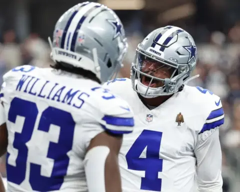 Dallas Cowboys football players celebrating on the field during a game, wearing team uniforms and helmets, in an exciting moment of the NFL season.