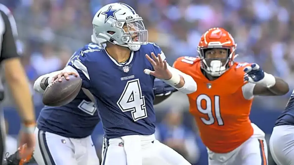 Dallas Cowboys quarterback Dak Prescott evades a tackle during an NFL game against the Denver Broncos, showcasing his agility and leadership on the field. The game highlights top football action and player skills.
