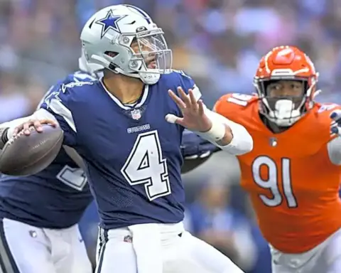 Dallas Cowboys quarterback Dak Prescott evades a tackle during an NFL game against the Denver Broncos, showcasing his agility and leadership on the field. The game highlights top football action and player skills.