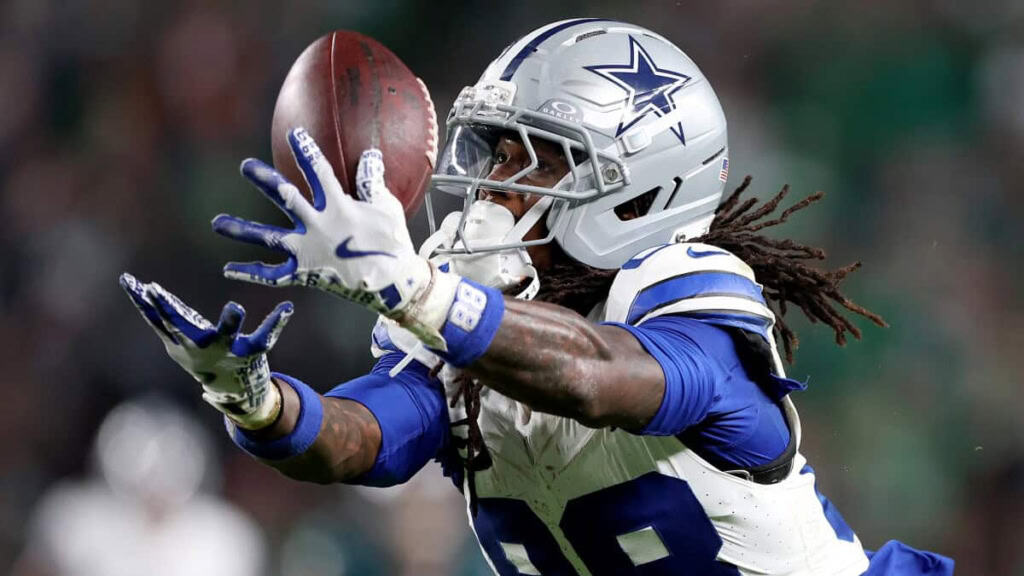 CeeDee Lamb of the Dallas Cowboys catching a football during an NFL game, showcasing his athleticism, skill, and focus on the field. Inside The Star provides expert analysis of Cowboys' players and games.