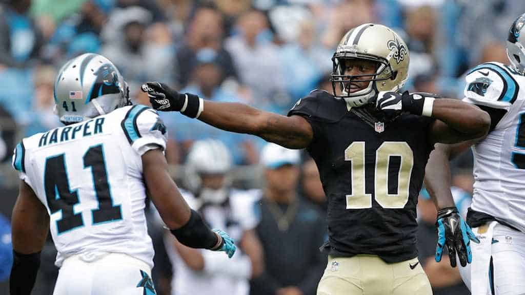 Golden State Warrior celebrating after scoring against the Charlotte Hornets, NFL game, action shot of football players in motion, stadium background, team uniforms and helmets.