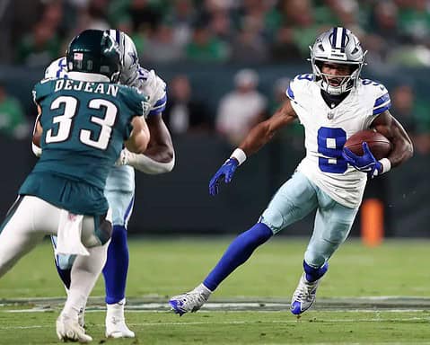 Dak Prescott carrying the football during a Dallas Cowboys game against the Jacksonville Jaguars. Focus on NFL football, Dallas Cowboys, and game action.