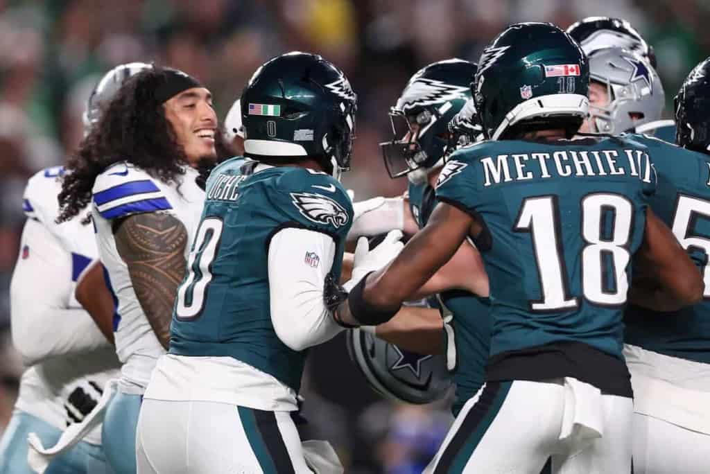 - NFL football players celebrating on the field, Dallas Cowboys vs. Philadelphia Eagles game, showing team spirit and football rivalry, inside the star stadium.