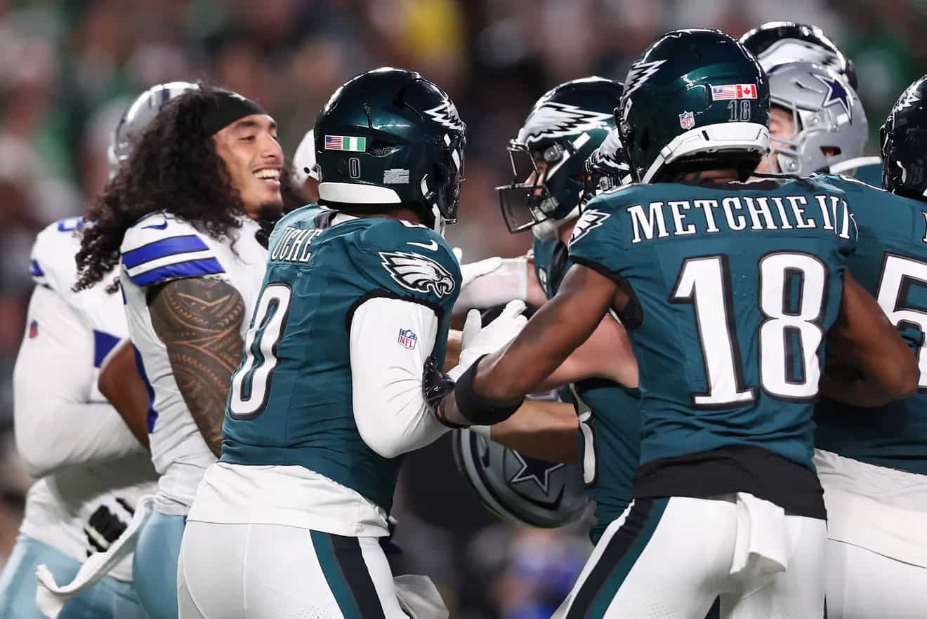 - NFL football players celebrating on the field, Dallas Cowboys vs. Philadelphia Eagles game, showing team spirit and football rivalry, inside the star stadium.