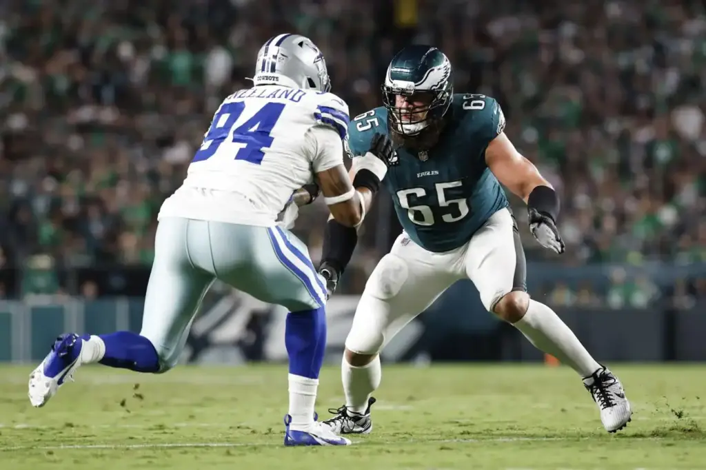 Aggressive football players competing on the field during a Dallas Cowboys versus Philadelphia Eagles game, highlighting NFL sports action and player rivalry.