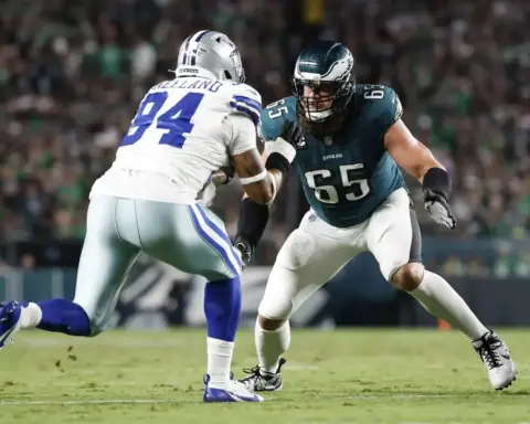 Aggressive football players competing on the field during a Dallas Cowboys versus Philadelphia Eagles game, highlighting NFL sports action and player rivalry.