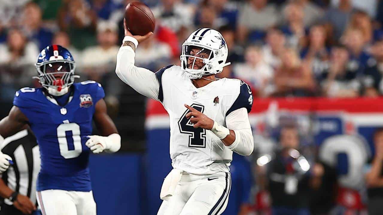 Quarterback Dak Prescott throwing a football during a Dallas Cowboys game at AT&T Stadium.
