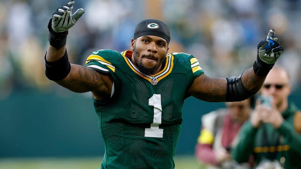 Ace of Green Bay Packers football player celebrating on the field during a game, wearing team uniform and gloves. Inside the Star logo and coverage of NFL and Green Bay Packers sports news.