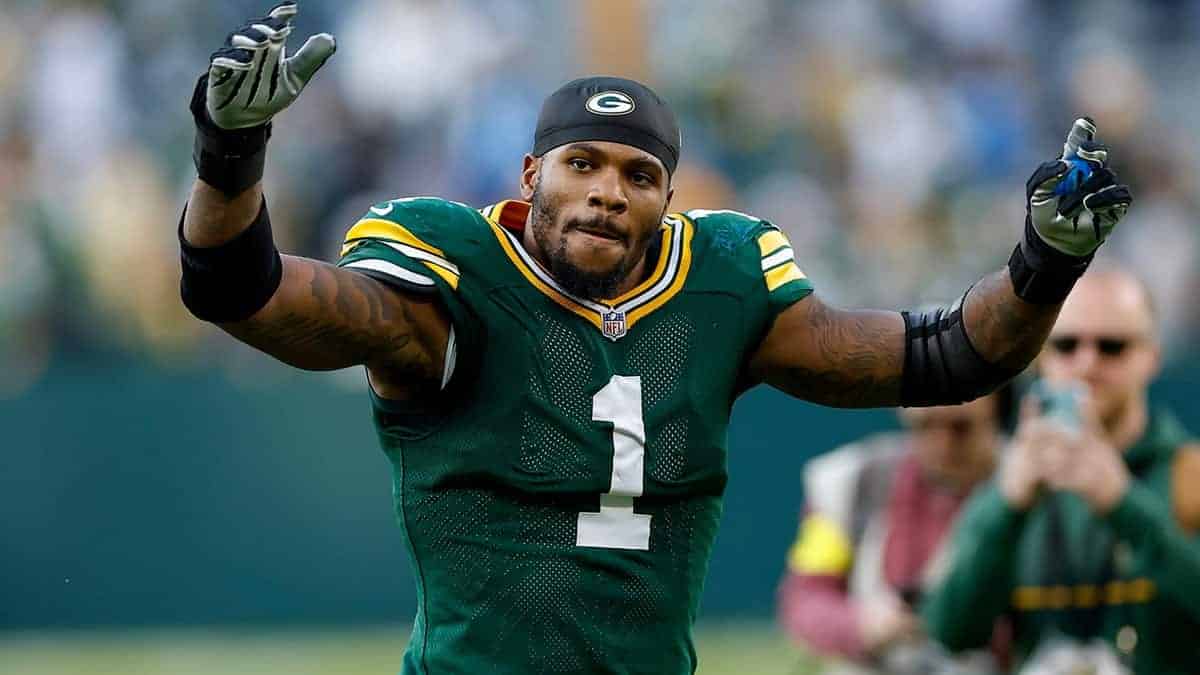 Ace of Green Bay Packers football player celebrating on the field during a game, wearing team uniform and gloves. Inside the Star logo and coverage of NFL and Green Bay Packers sports news.
