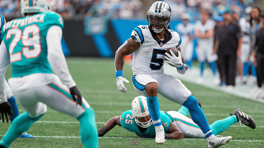 Carolina Panthers running back Rico Dowdle runs past Miami Dolphins linebacker Tyrel Dodson during the first half of an NFC football game, Sunday, Oct. 5, 2025, in Charlotte, N.C. (AP Photo/Jacob Kupferman)