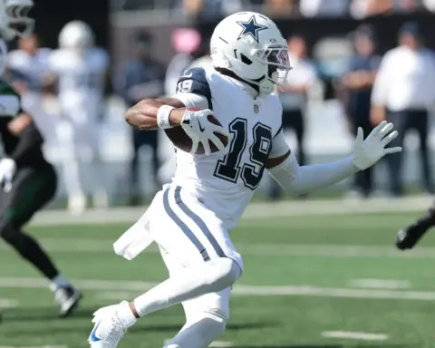 Running back with football in Dallas Cowboys uniform during NFL game.