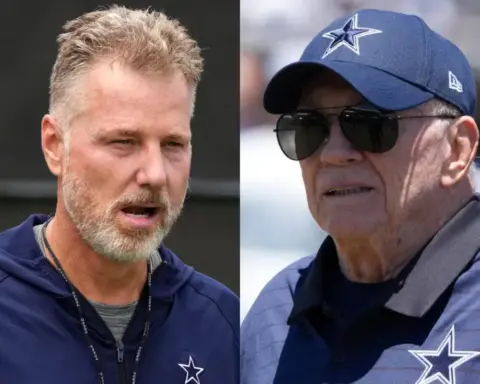 Dallas Cowboys football coach speaking during a game, wearing team gear and headset; veteran coach and young coach involved in Dallas Cowboys football team.
