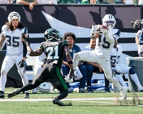 Inside The Star: Dallas Cowboys football players in action during a game, showcasing player skills and game intensity at AT&T Stadium, highlighting Dallas Cowboys' team performance.
