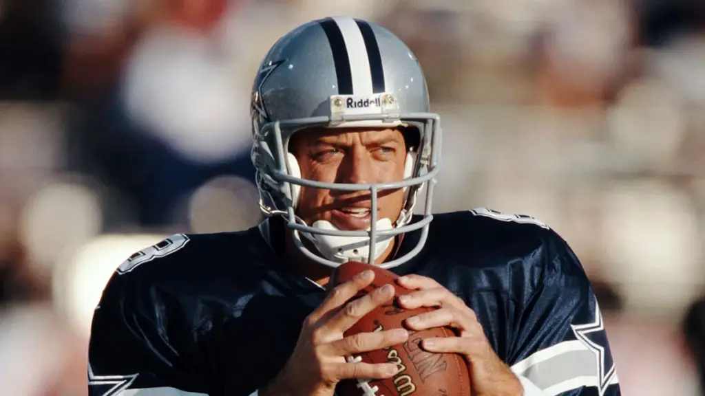 Focused Dallas Cowboys quarterback in action, preparing to throw a football during a game at AT&T Stadium. Highlights NFL football, sports performance, and American football gameplay.
