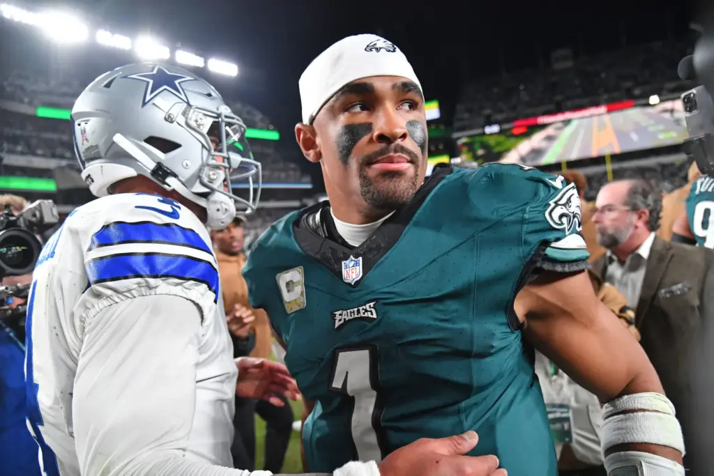 Dallas Cowboys vs Philadelphia Eagles game, NFL football player in green jersey, team captain, standing on the field in a stadium, focused expression, game action, sports photography, Inside The Star.