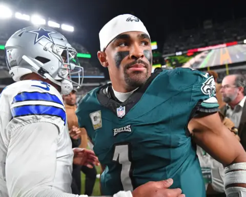 Dallas Cowboys vs Philadelphia Eagles game, NFL football player in green jersey, team captain, standing on the field in a stadium, focused expression, game action, sports photography, Inside The Star.