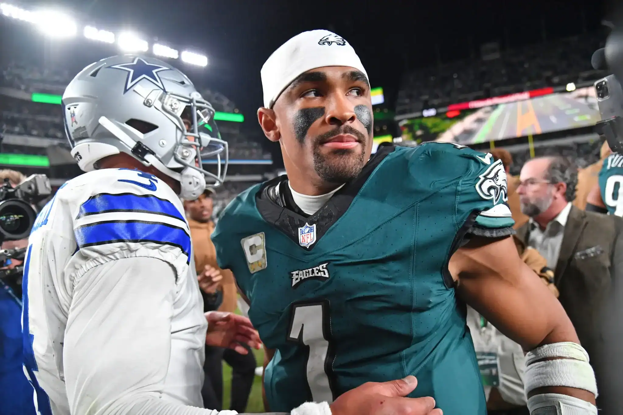 Dallas Cowboys vs Philadelphia Eagles game, NFL football player in green jersey, team captain, standing on the field in a stadium, focused expression, game action, sports photography, Inside The Star.