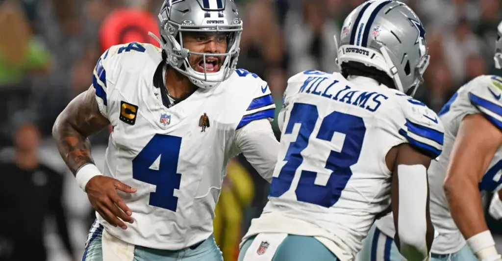 Dallas Cowboys quarterback Dak Prescott celebrating with teammates during a game, showcasing team spirit and leadership on the field.