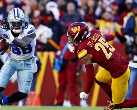Exploring an intense football game between Dallas Cowboys and Washington Football Team, featuring a Cowboy running with the ball as a Washington defender attempts to tackle him on the field.