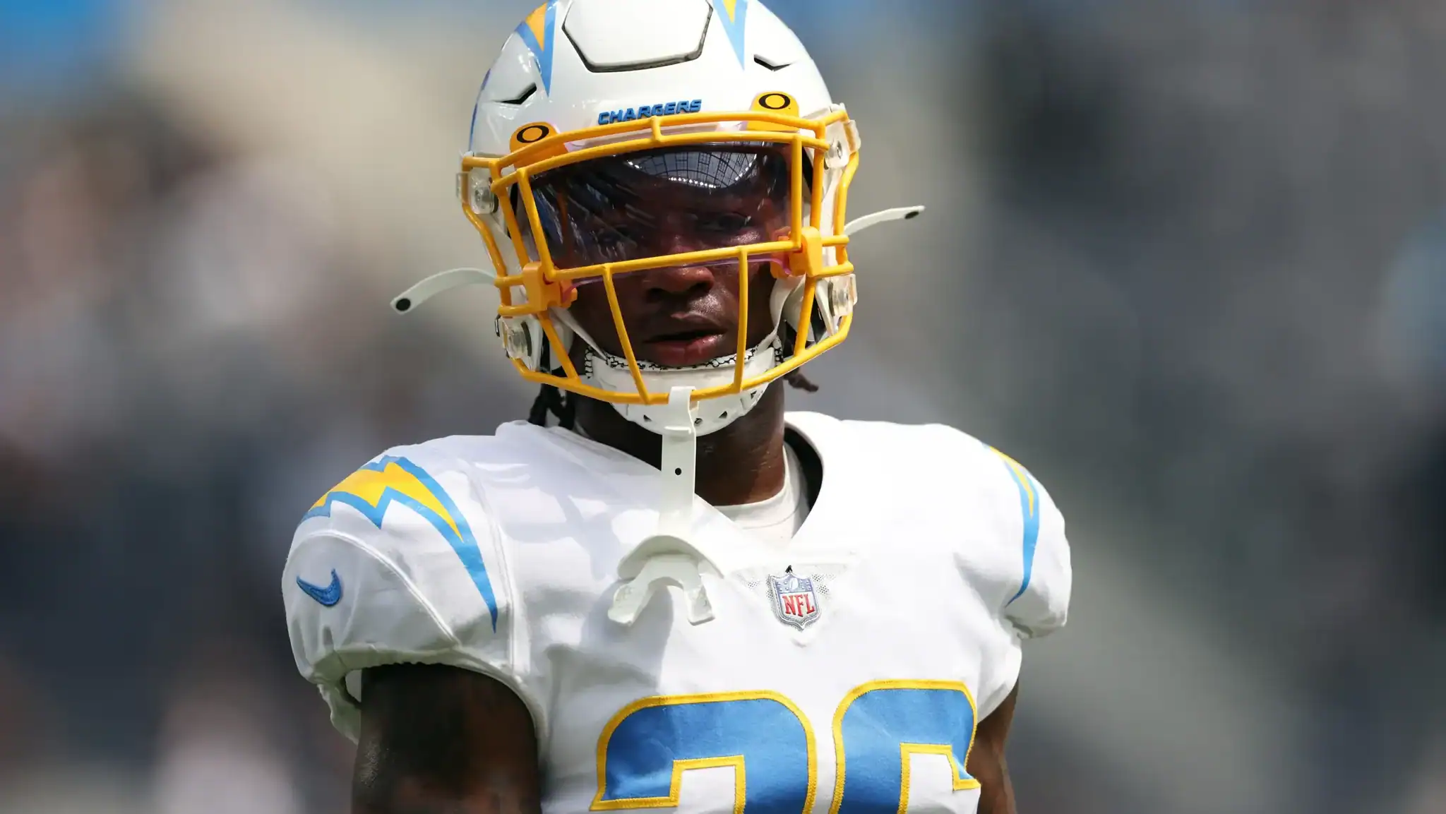 Rugby player wearing helmet and white jersey with blue and yellow accents, focused on the game, inside the star-themed sports blog.