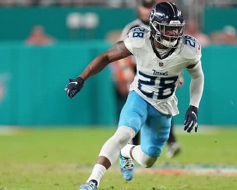 Athlete in the Dallas Cowboys jersey running on the football field during a game, capturing the excitement of NFL football.