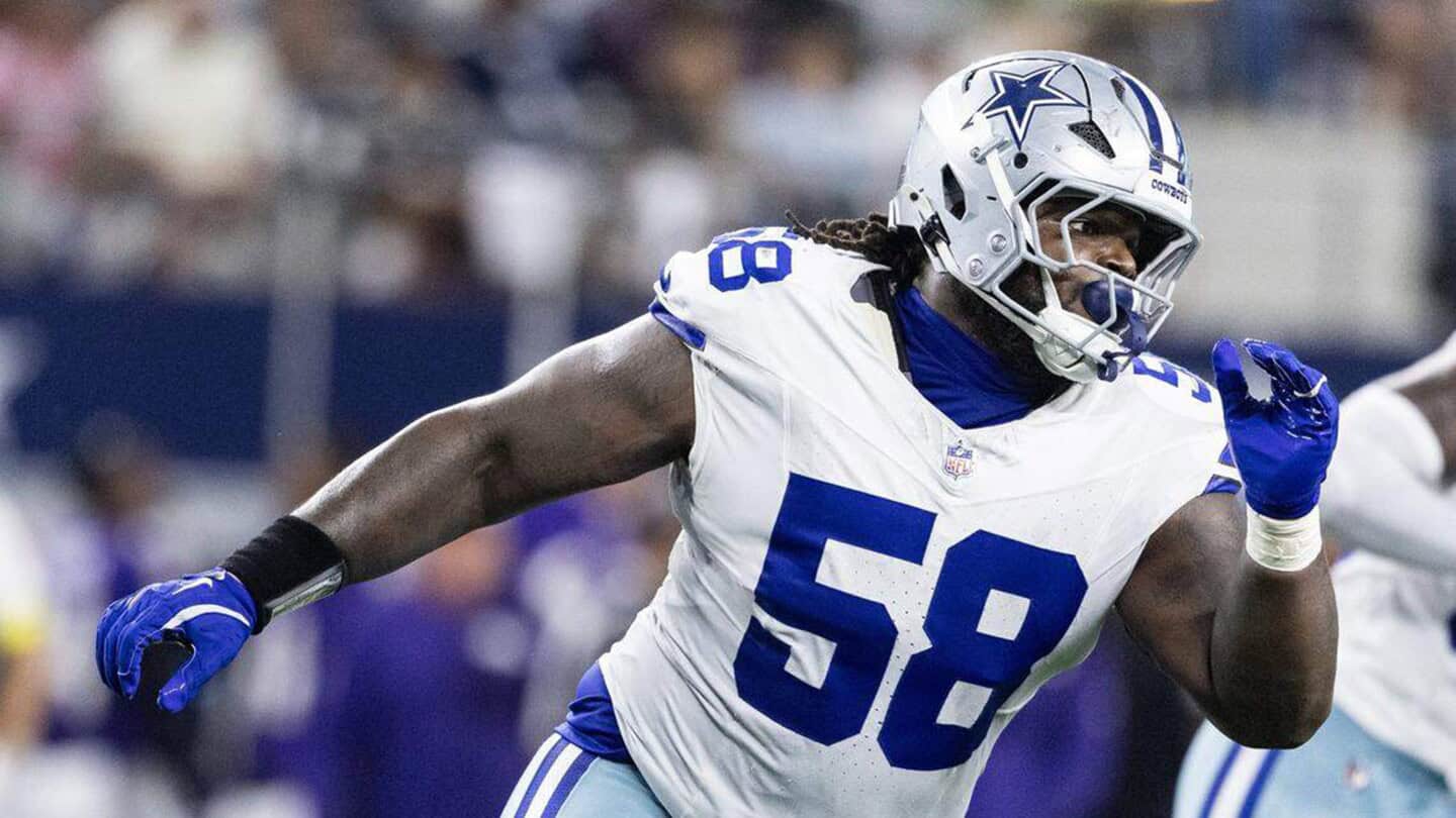 Dallas Cowboys linebacker in game action, wearing white jersey number 58, with a helmet featuring Cowboys star logo, on the football field during an NFL game.