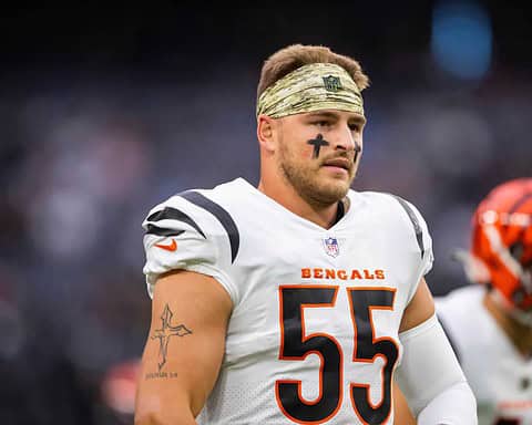 Baltimore Ravens football player wearing a white jersey with number 55, camo headband, and face paint, during a game on the field.